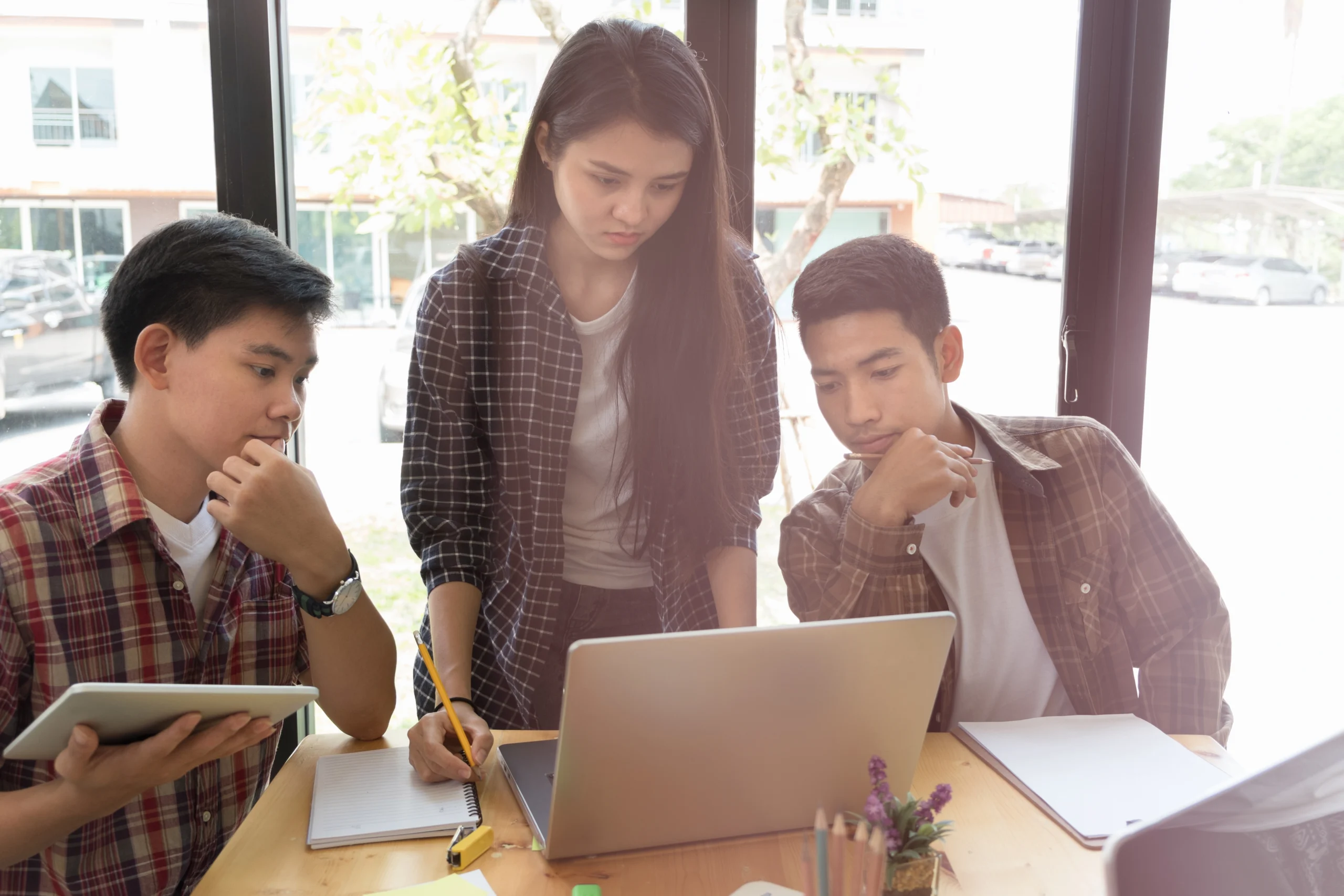 three young Gen Z workers working together