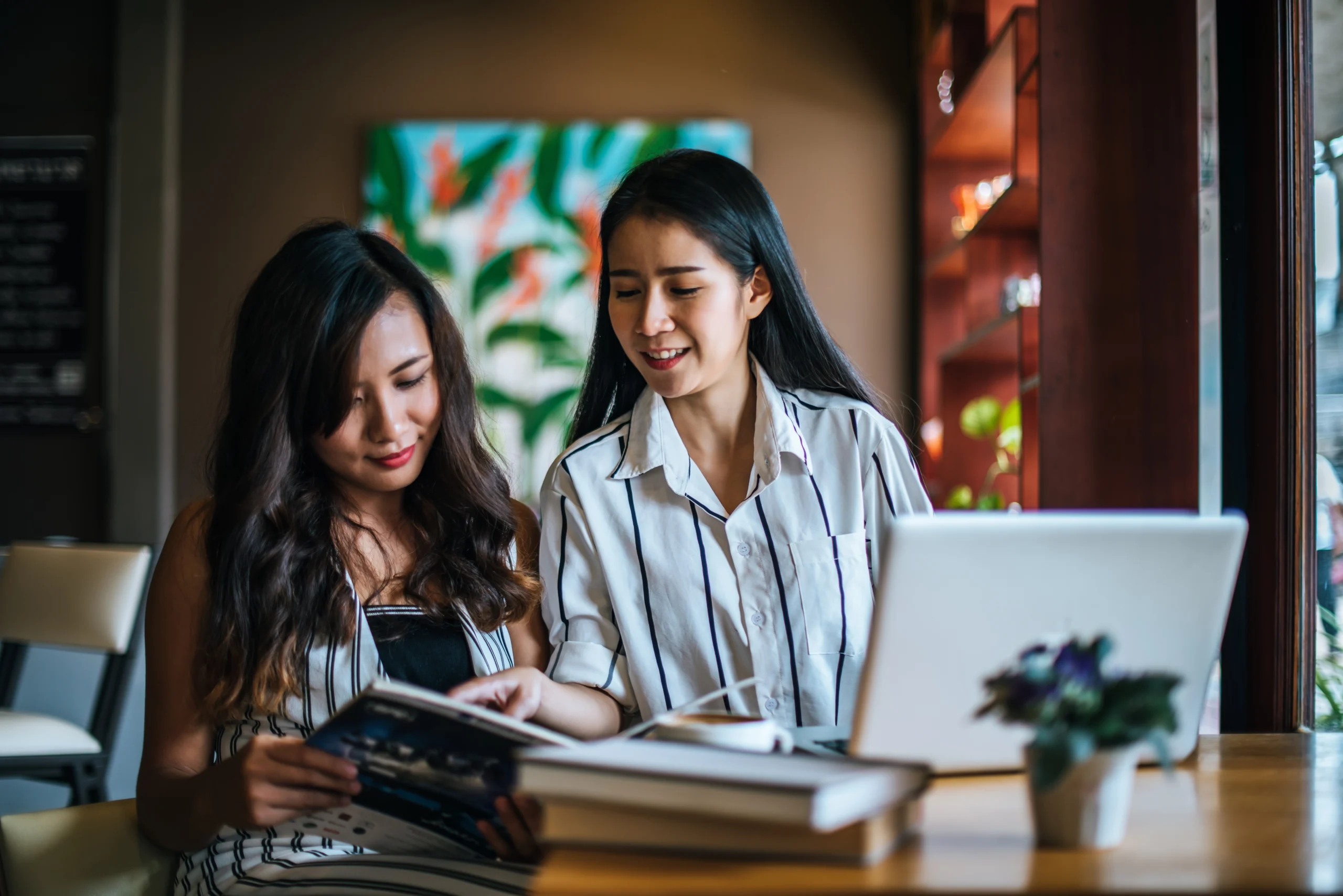 two young women are working together