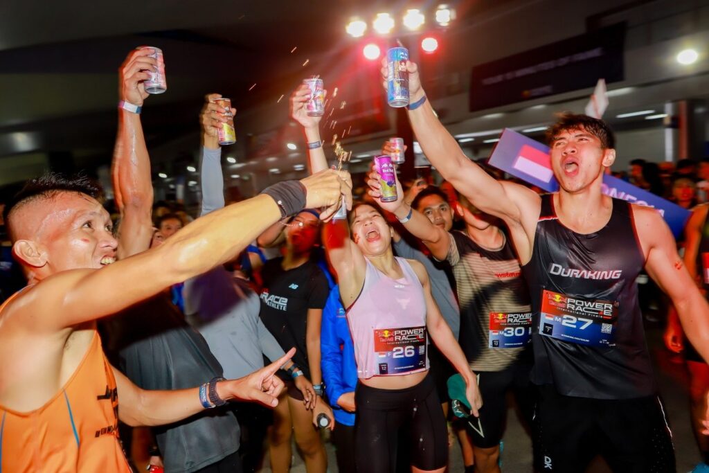 Athletes from different nations celebrate together after racing in Bangkok