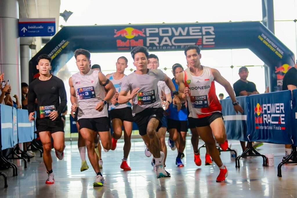 Male athletes sprint away from the start arch at the International Final in Bangkok