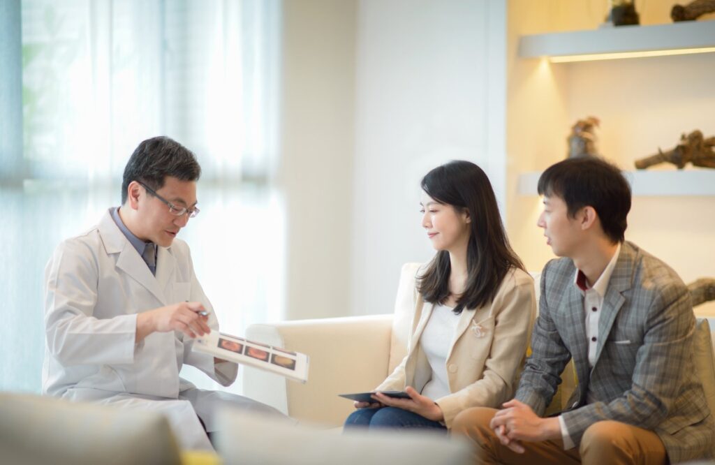 Physician explaining Taipei health screening results to a couple