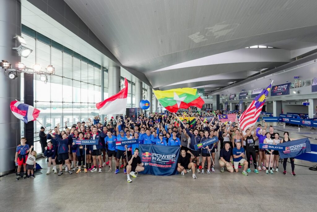 Athletes from Thailand, Indonesia, Myanmar and Malaysia wave their flags at the Red Bull Power Race International Final in Bangkok